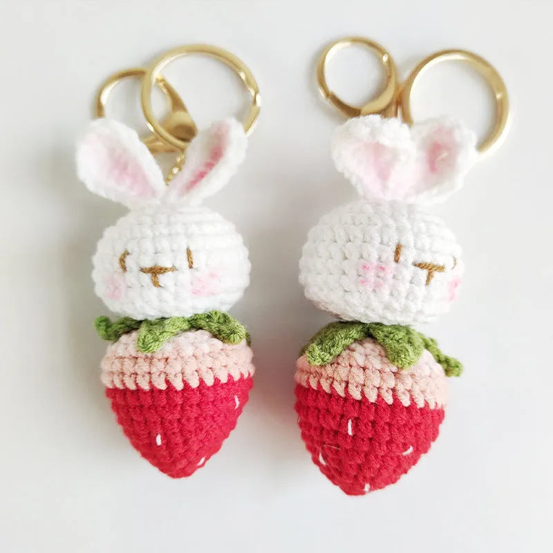 White hand-woven wire pendant with rabbit and strawberry design on a key fitting.