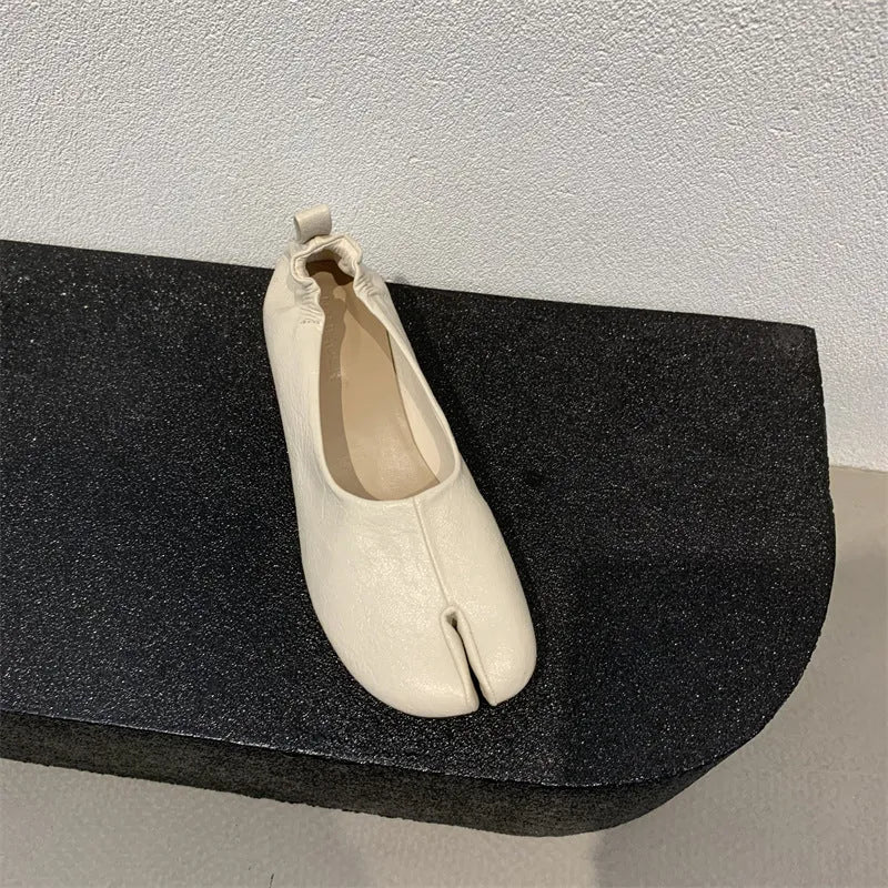 Women's round toe pumps with a split toe horseshoe design and a chunky low heel.