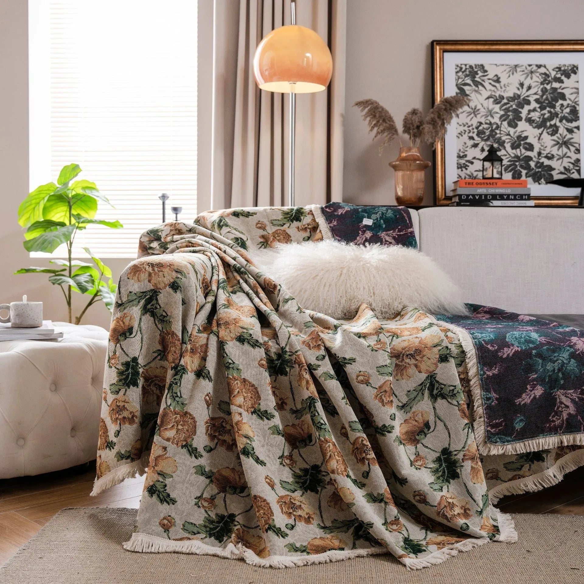 American country style jacquard patterned sofa cover in a green colourway draped over a sofa.