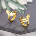 A pair of simple women's fishtail earrings with an electroplated finish in white gold or yellow gold colour.