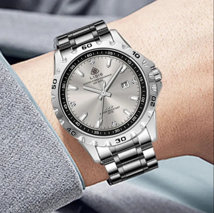 Silver men's business watch with luminous hands on stainless steel strap