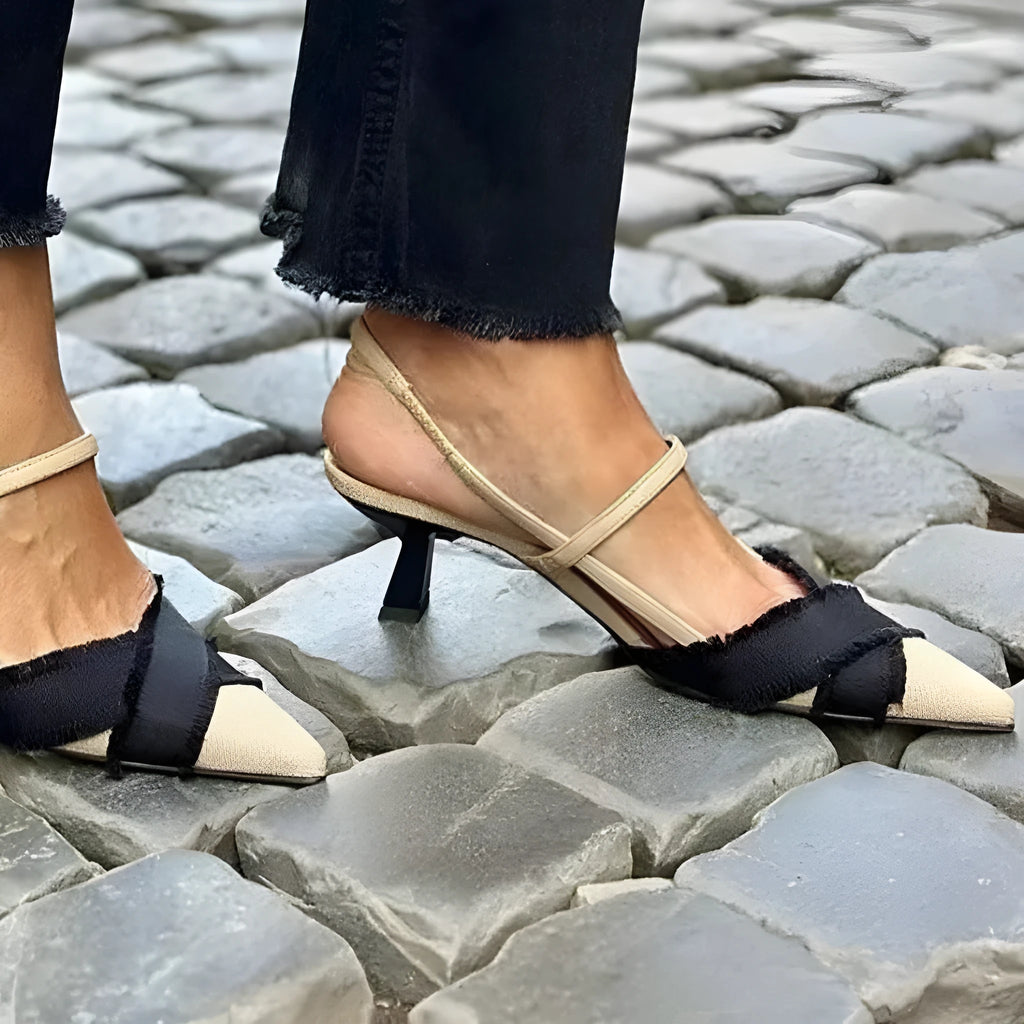 Apricot and black women's stiletto sandals with a buckle strap and pointed toe.