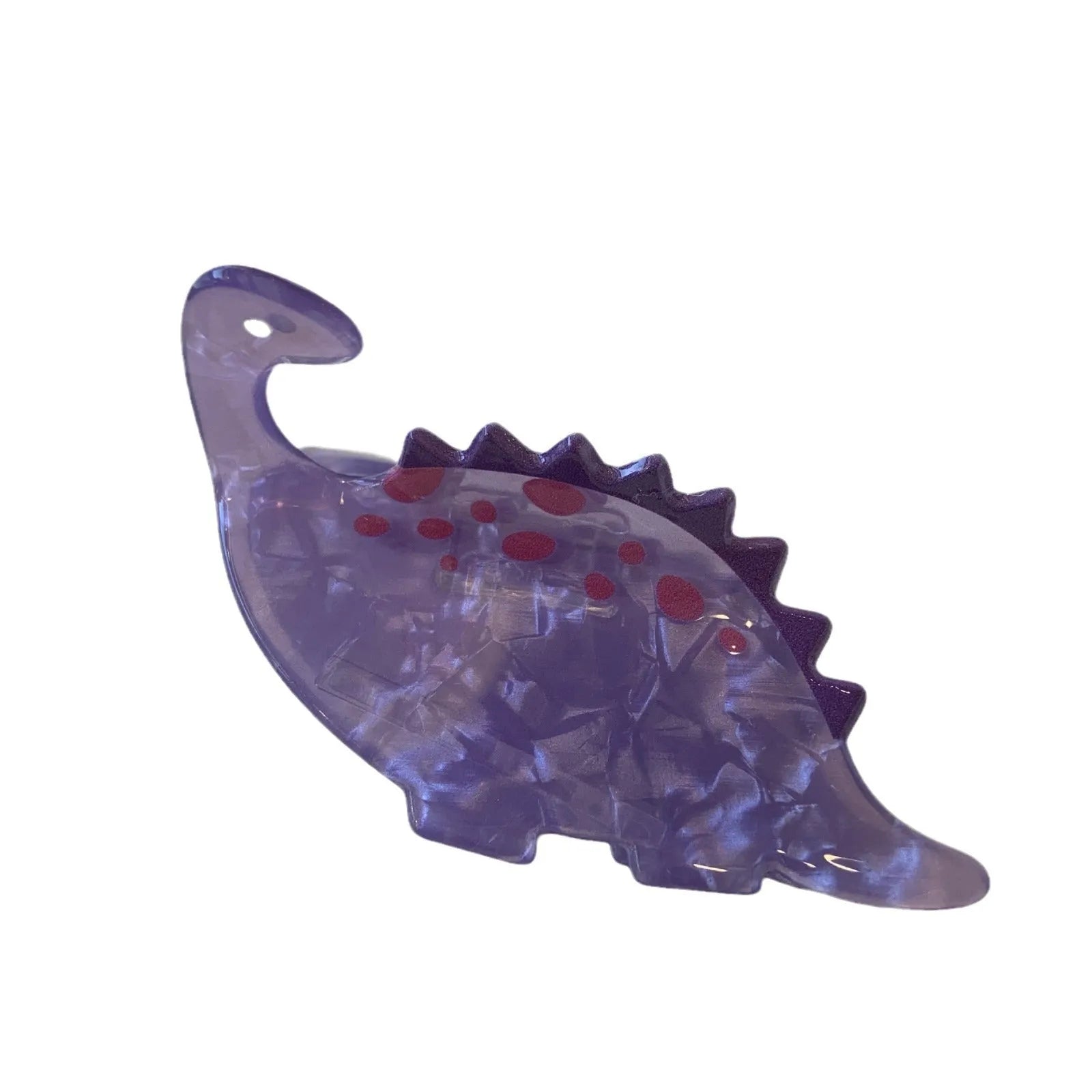 Dinosaur acrylic jaw clip hairpin in six colours including pink pterosaur and green stegosaurus on neutral background