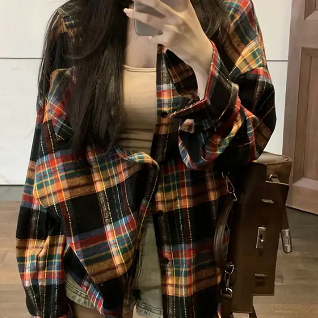 Women's loose fit black and green plaid cotton shirt with long sleeves on a hanger.