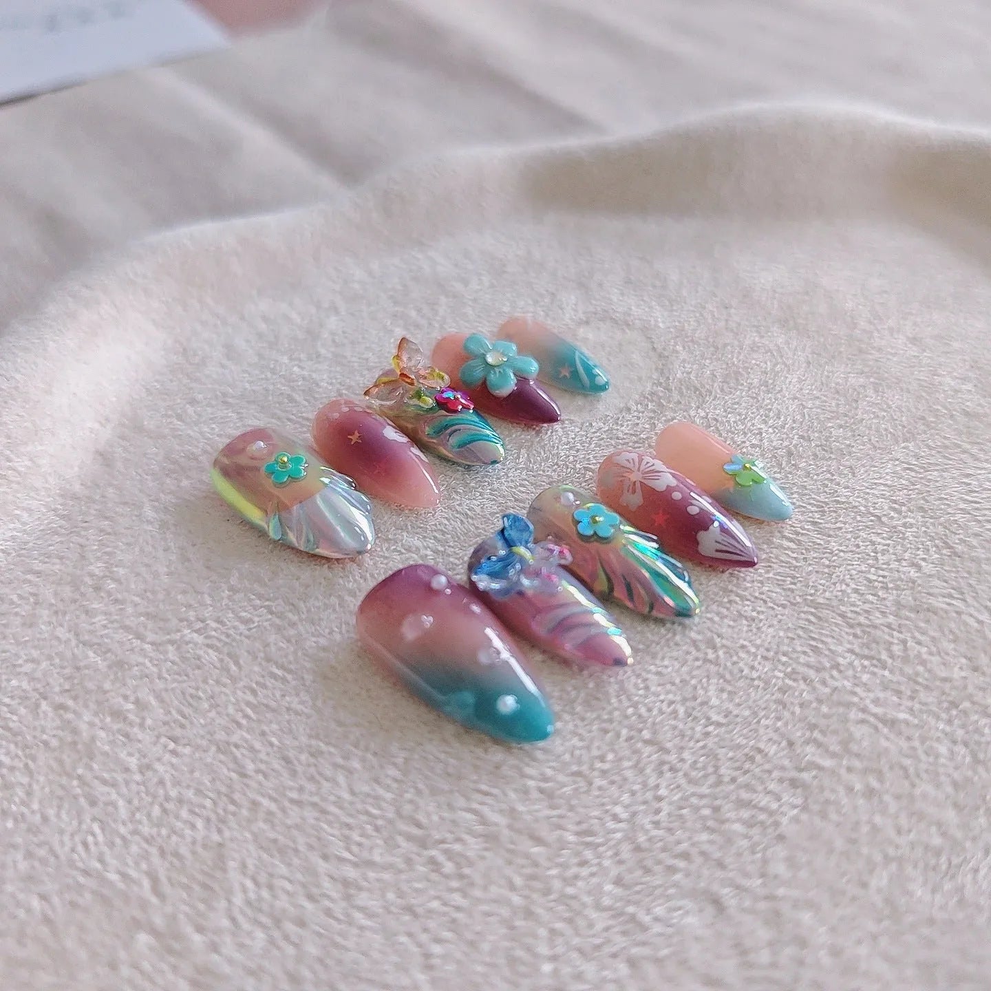 Handmade 3D flower and butterfly nail art sculptures in colourful press-on manicure designs
