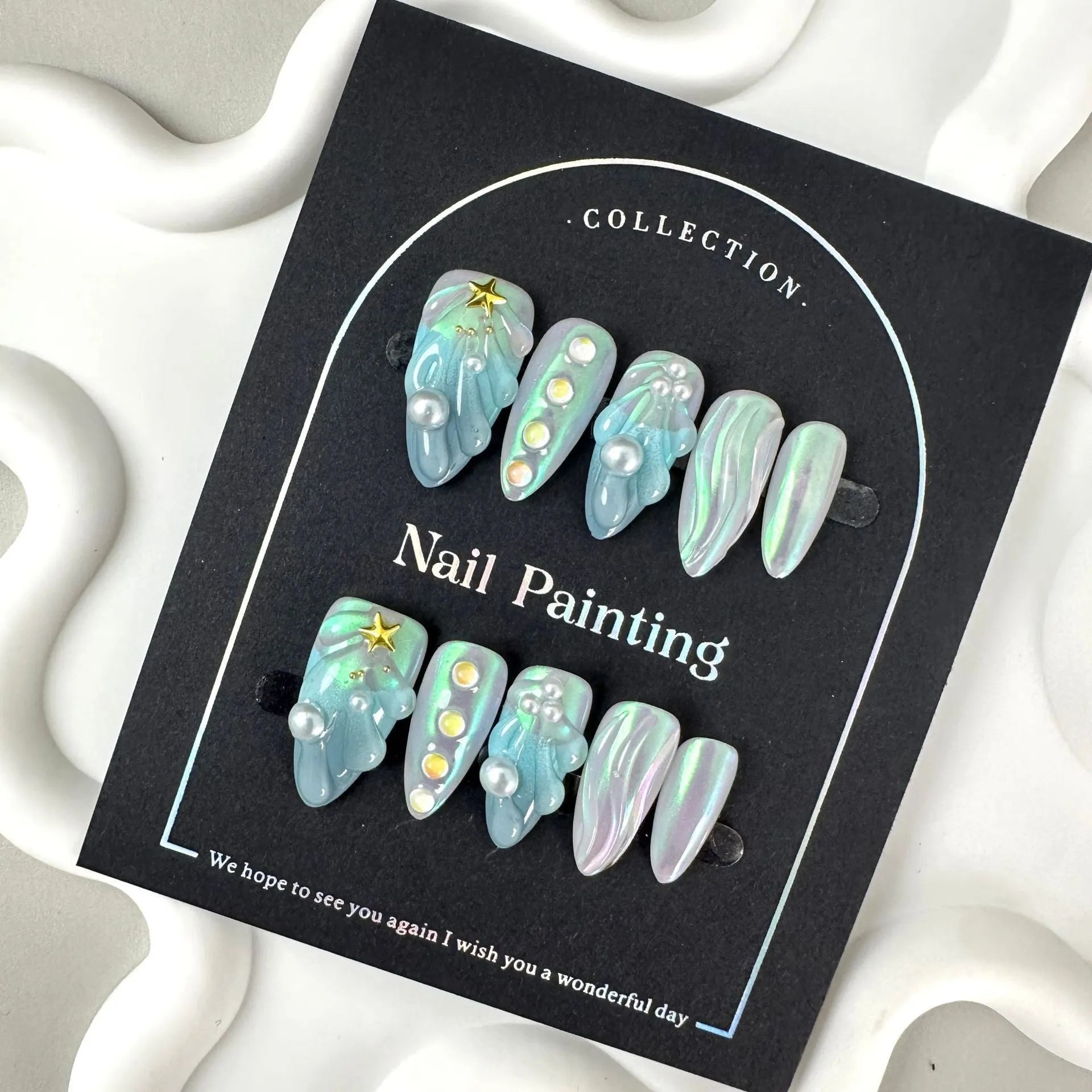 Blue plastic HAILANG false nail tips set showing sizes XS, S, M, L on a card.