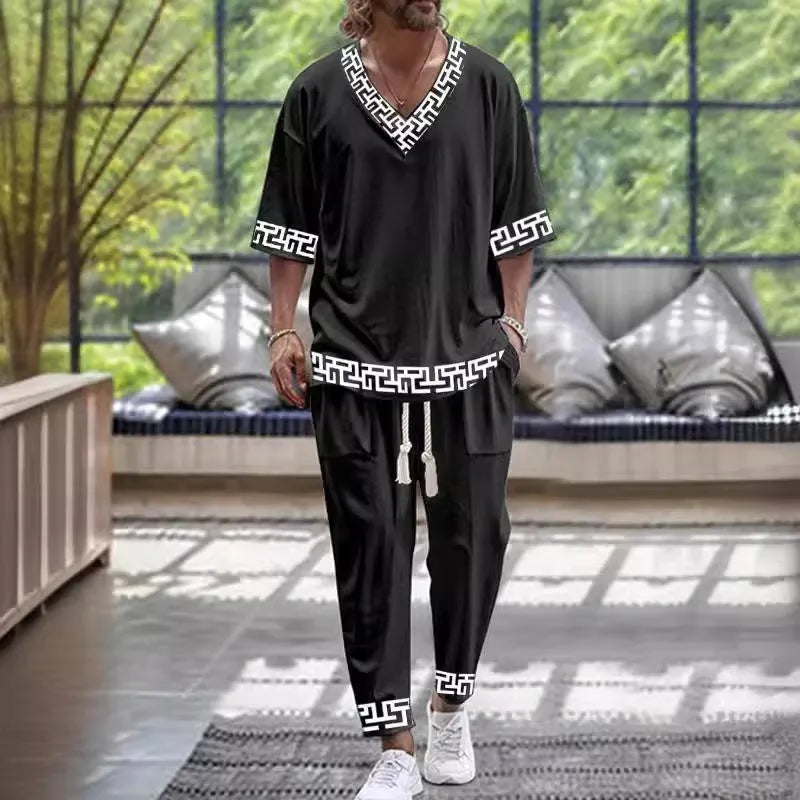 Lightweight grey polyester two-piece trousers suit with V-neck jacket and matching trousers on a hanger.
