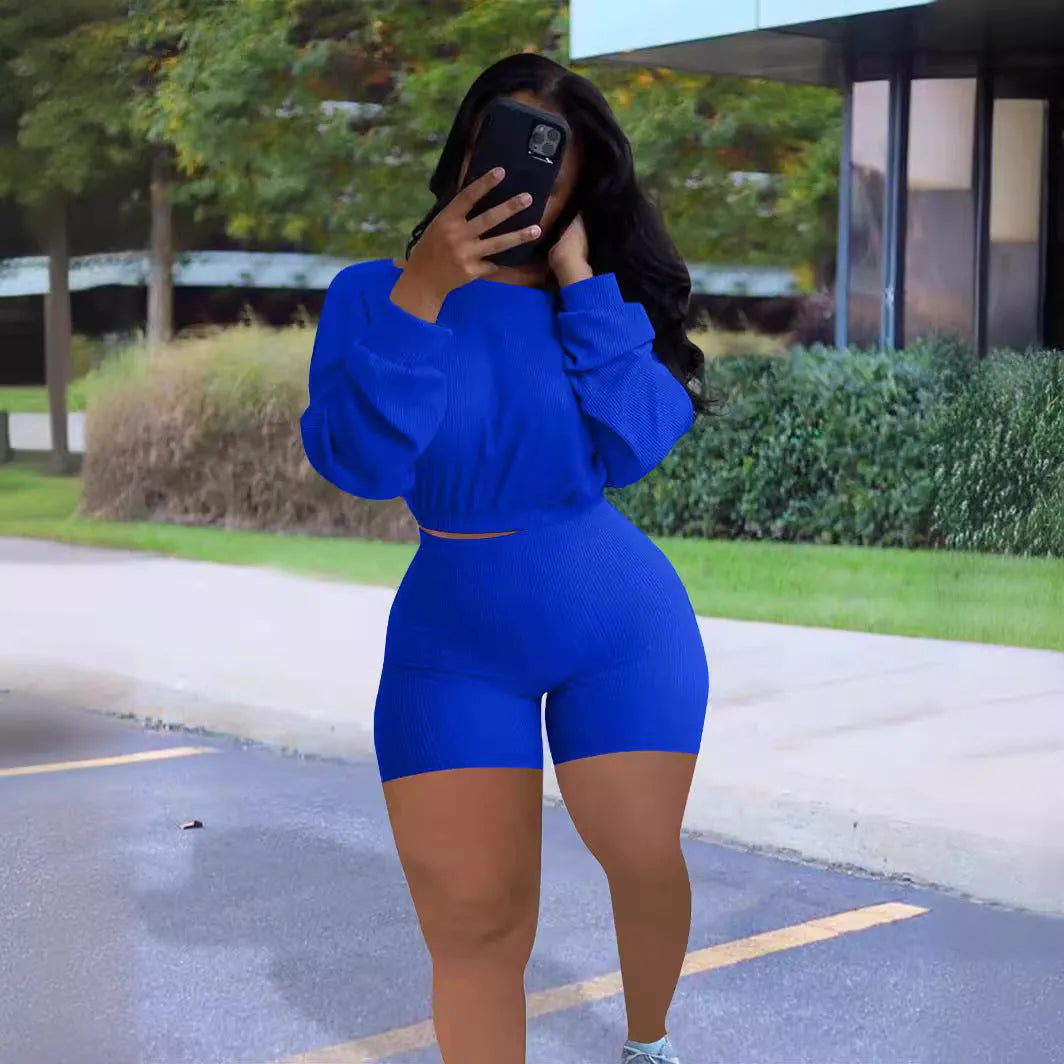 Women's off-the-shoulder long sleeve top and shorts two-piece set in a solid colour with a sunken stripe pattern.