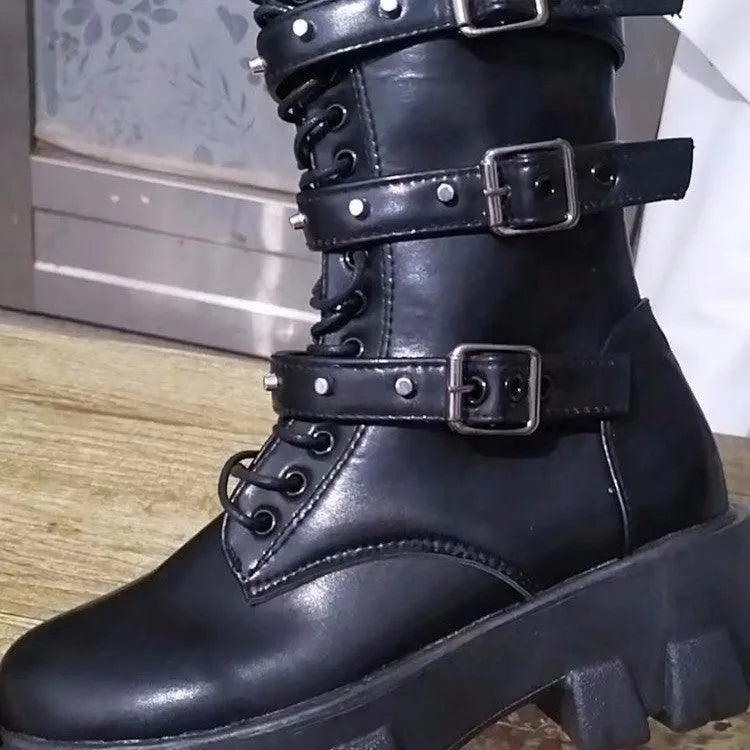 Black mid-calf women's boots with a prominent buckle detail and side zipper on a white background.