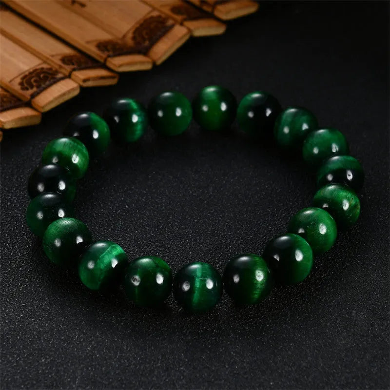 Green tiger eye stone bracelet with polished geometric beads in natural stone material