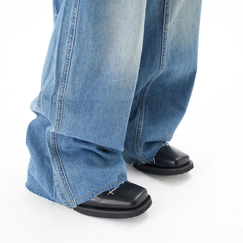 Light blue vintage washed wide leg machete jeans with zip fly on a model