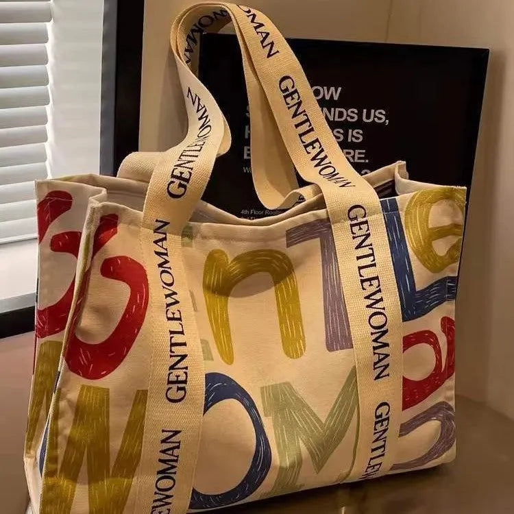 Canvas women's travel tote shopping bag with printed design in unisex style
