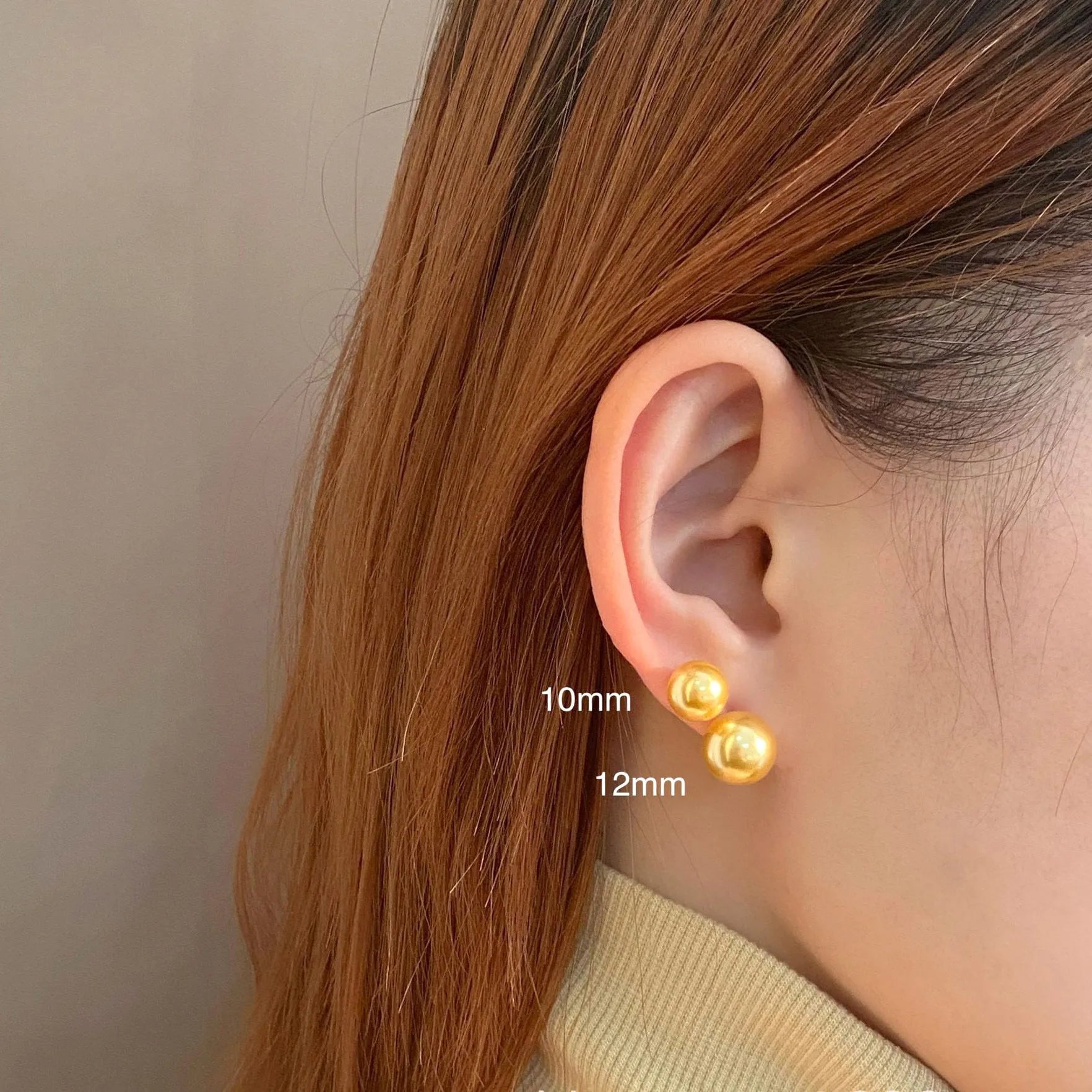 A pair of large geometric pearl stud earrings with an eight-point star accent on a silver setting.