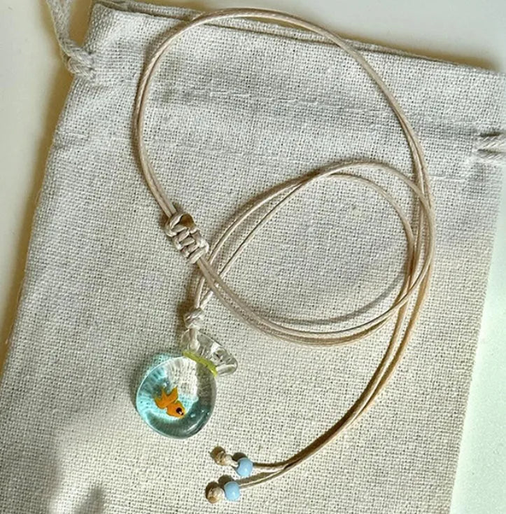 Women's pendant necklace with coloured glaze joker charm on cotton linen chain