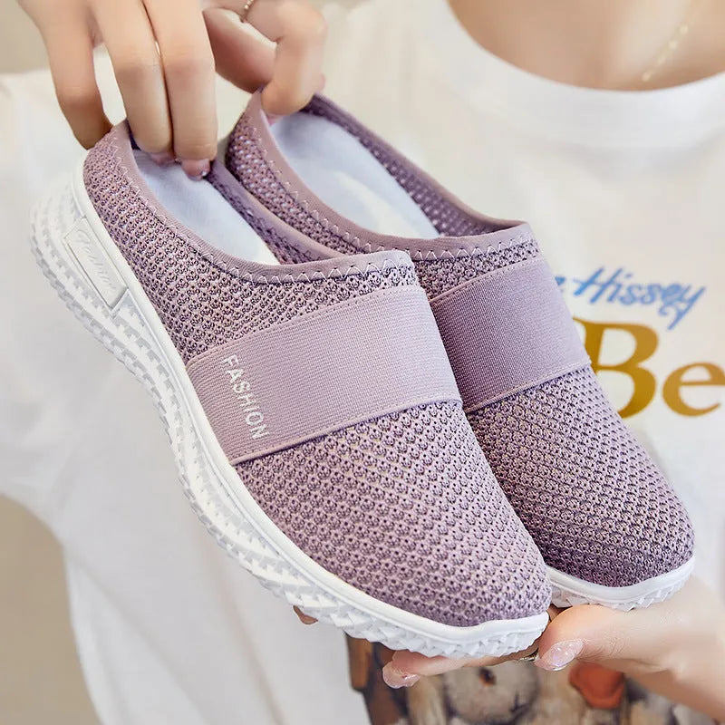 Women's breathable mesh casual shoes in black with a hollow out design and flat heel.