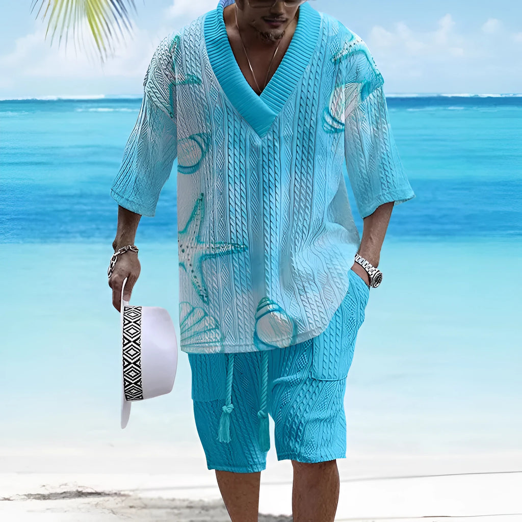 Man wearing a loose blue short sleeve casual suit top and matching shorts.