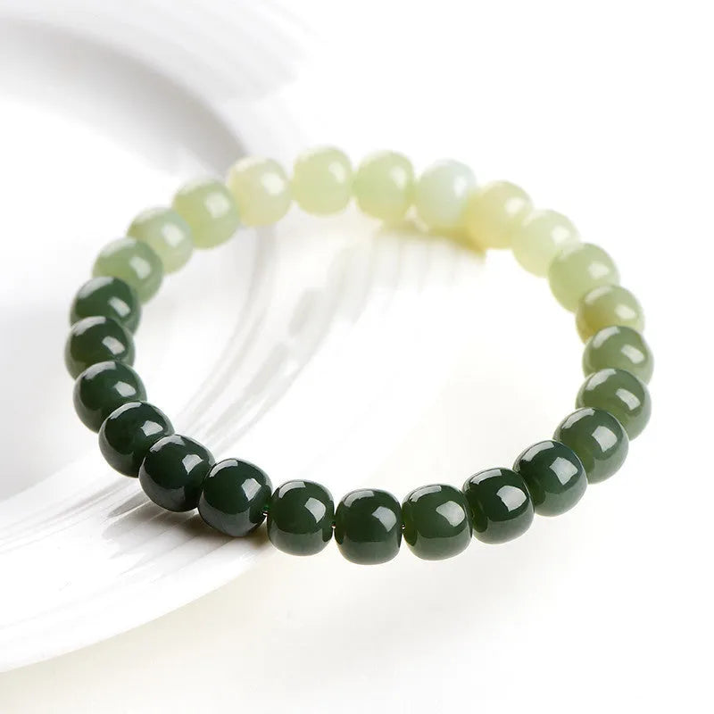 Natural Hetian jade bracelet with clear water gradient on wrist.