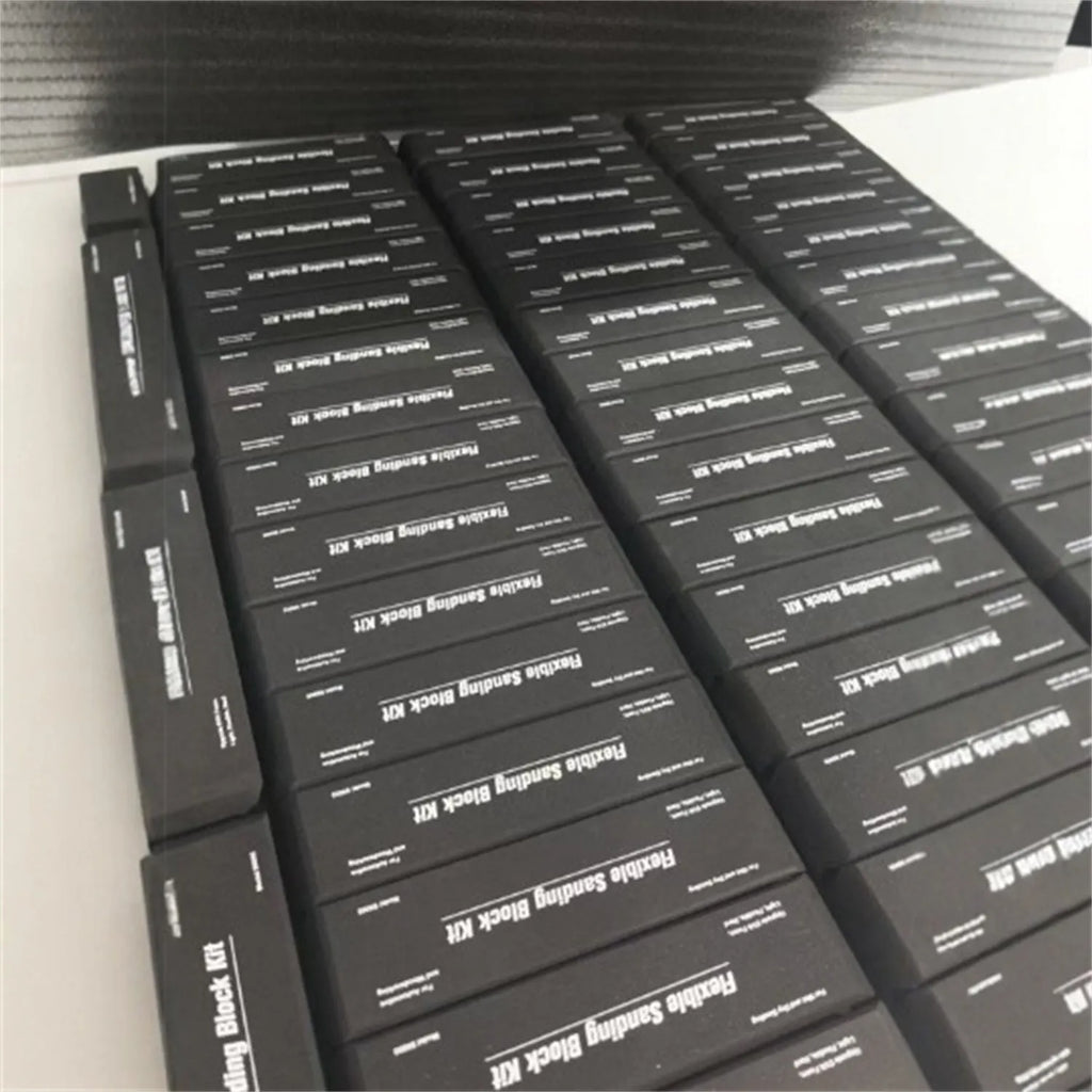 Set of seven black frosted metal alignment blocks for workshop use.
