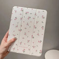 Transparent floral tri-fold hard case for iPad showing magnetic closure and stylus loop.