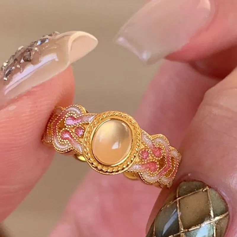 Women's open mouth ring with geometric shape, gold plating, and pink crystal enamel accents