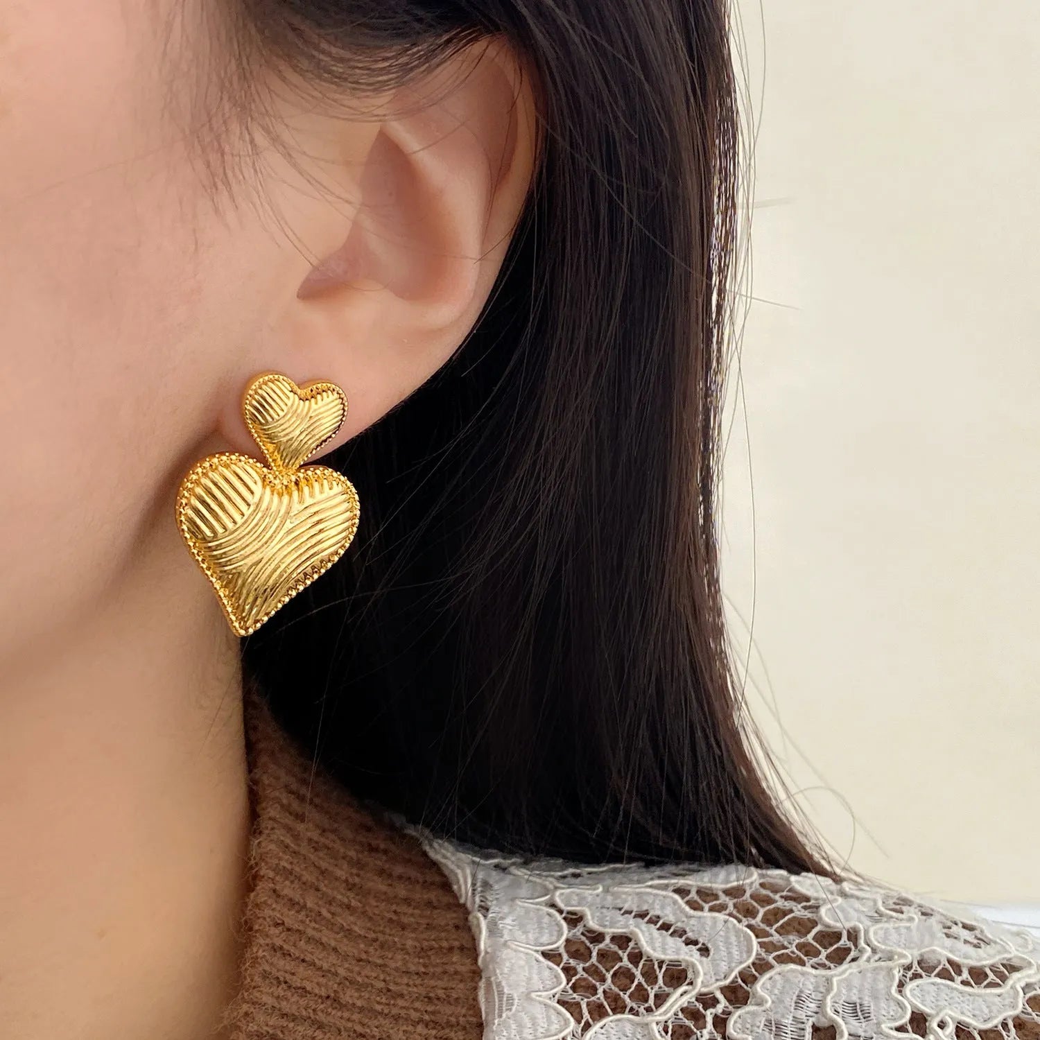 Double heart copper earrings with electroplated finish, available as ear clips or ear studs
