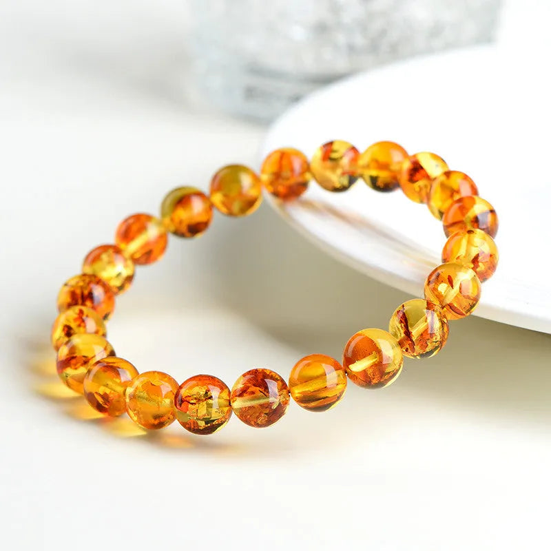 Natural yellow piebald amber bracelet with flower spot patterning and geometry beads