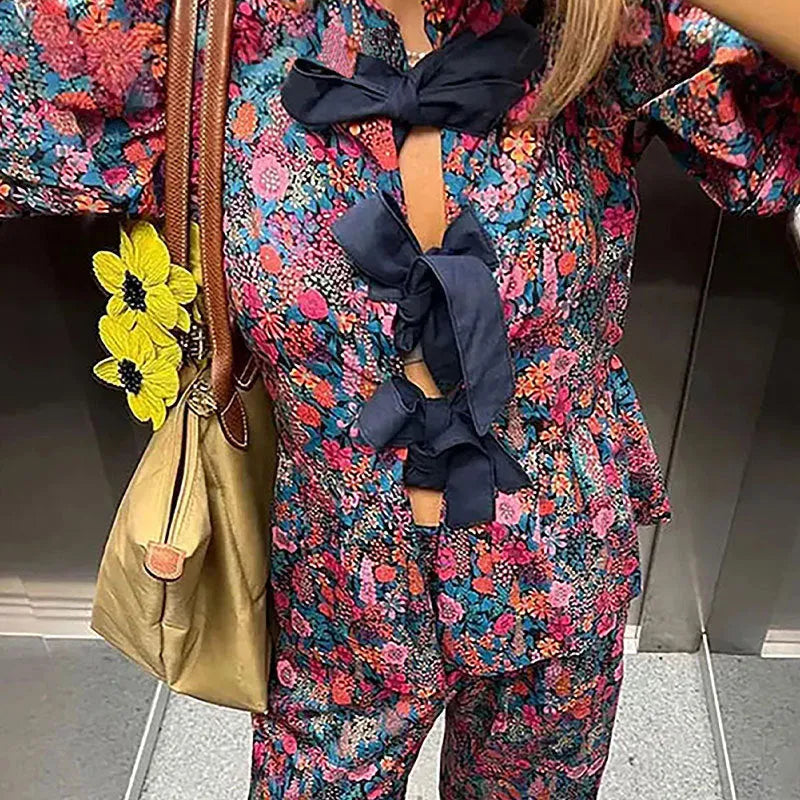 Floral printed women's trouser suit with puff sleeve top and tie-neck