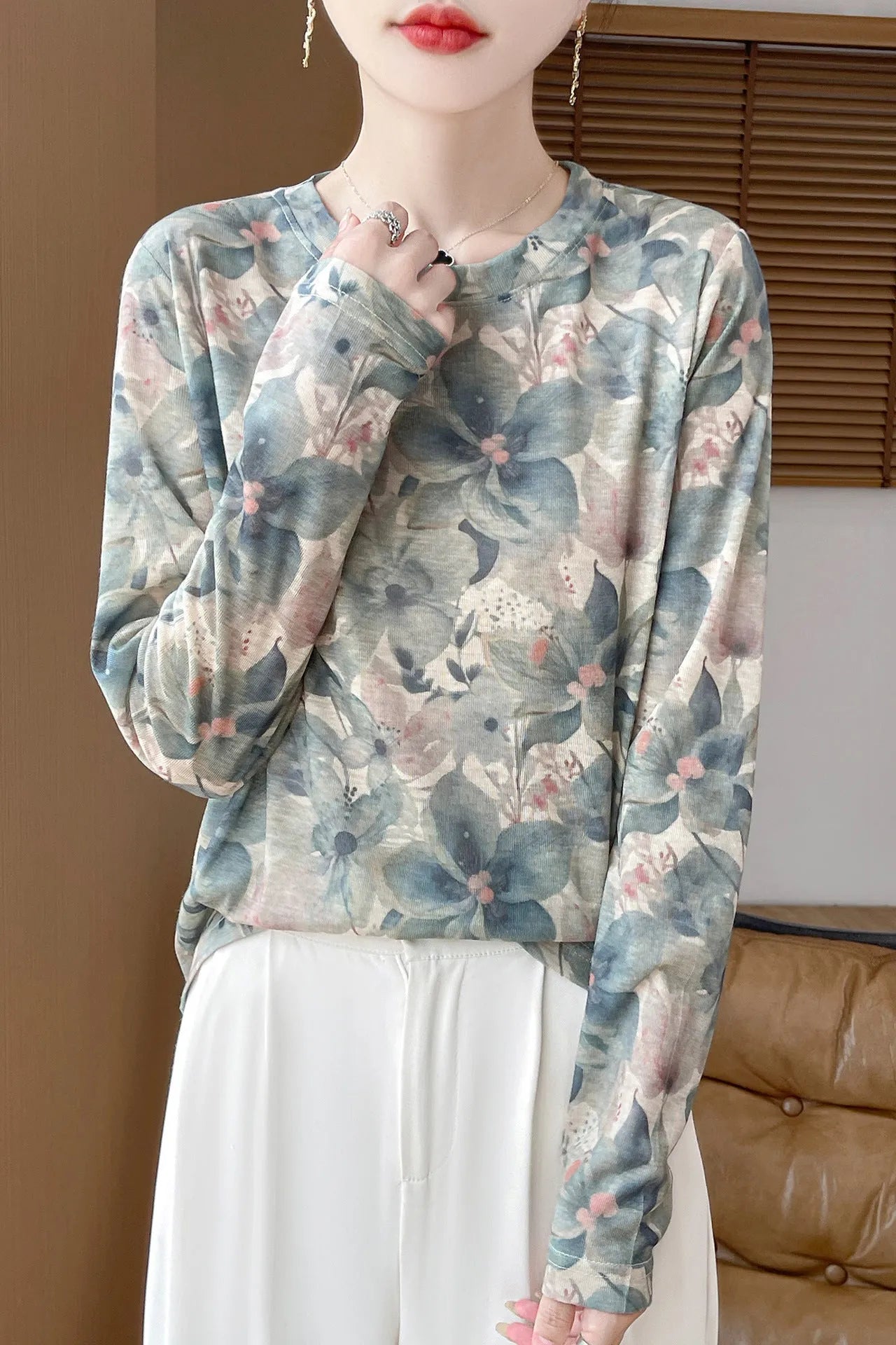 Women's round neck floral print pullover top in Tencel cotton fabric on a hanger.