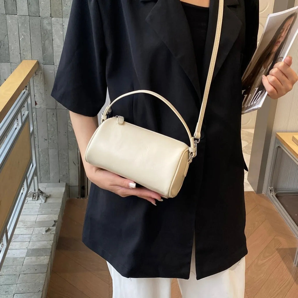 Genuine leather cylindrical crossbody phone bag in multiple colours with an adjustable strap.