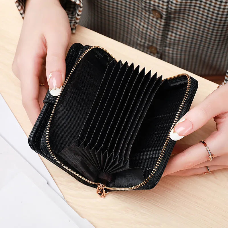 A beige ladies' short wallet with a textured lychee pattern, shown folded closed.