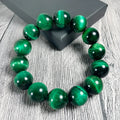 Green tiger eye stone bracelet with polished geometric beads in natural stone material