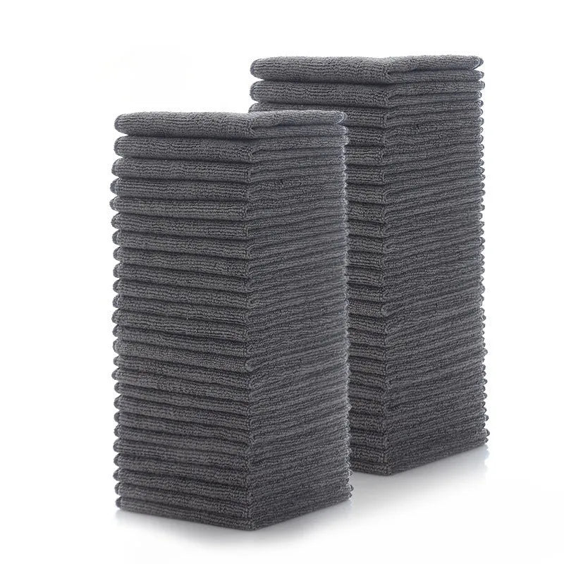 Grey square microfiber kitchen cleaning cloth for oil and grime on pots and bowls.