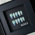 Blue plastic HAILANG false nail tips set showing sizes XS, S, M, L on a card.