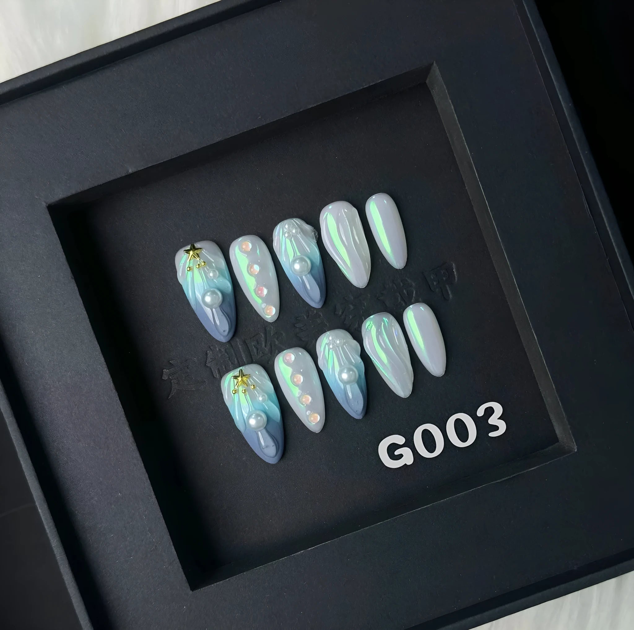 Blue plastic HAILANG false nail tips set showing sizes XS, S, M, L on a card.