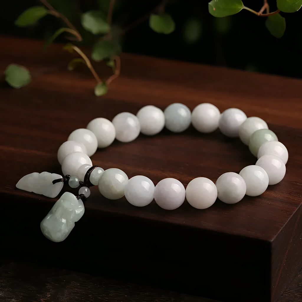 Natural emerald green jade hanging bracelet with Maitreya Buddha design on a geometric shape.