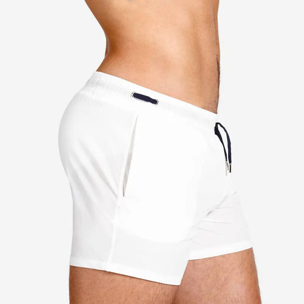 Men's solid colour polyester shorts with mesh lining for swimming and sports.