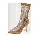 Gold women's stiletto high heel sandals with mesh upper and pointed toe on a rubber sole.
