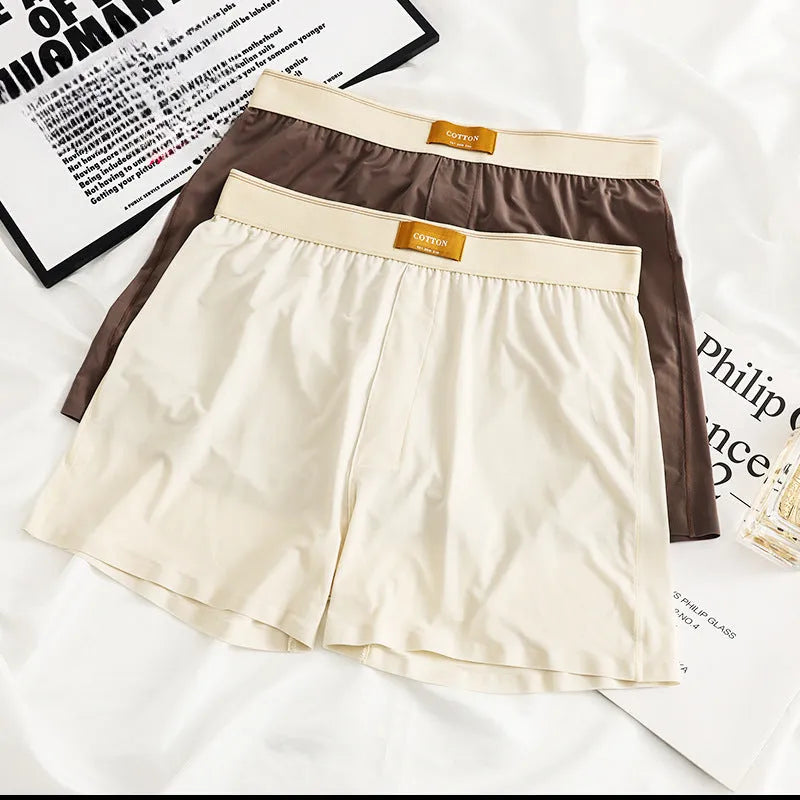 Pack of three pairs of solid colour men's loose fit ice silk underwear on a white background.