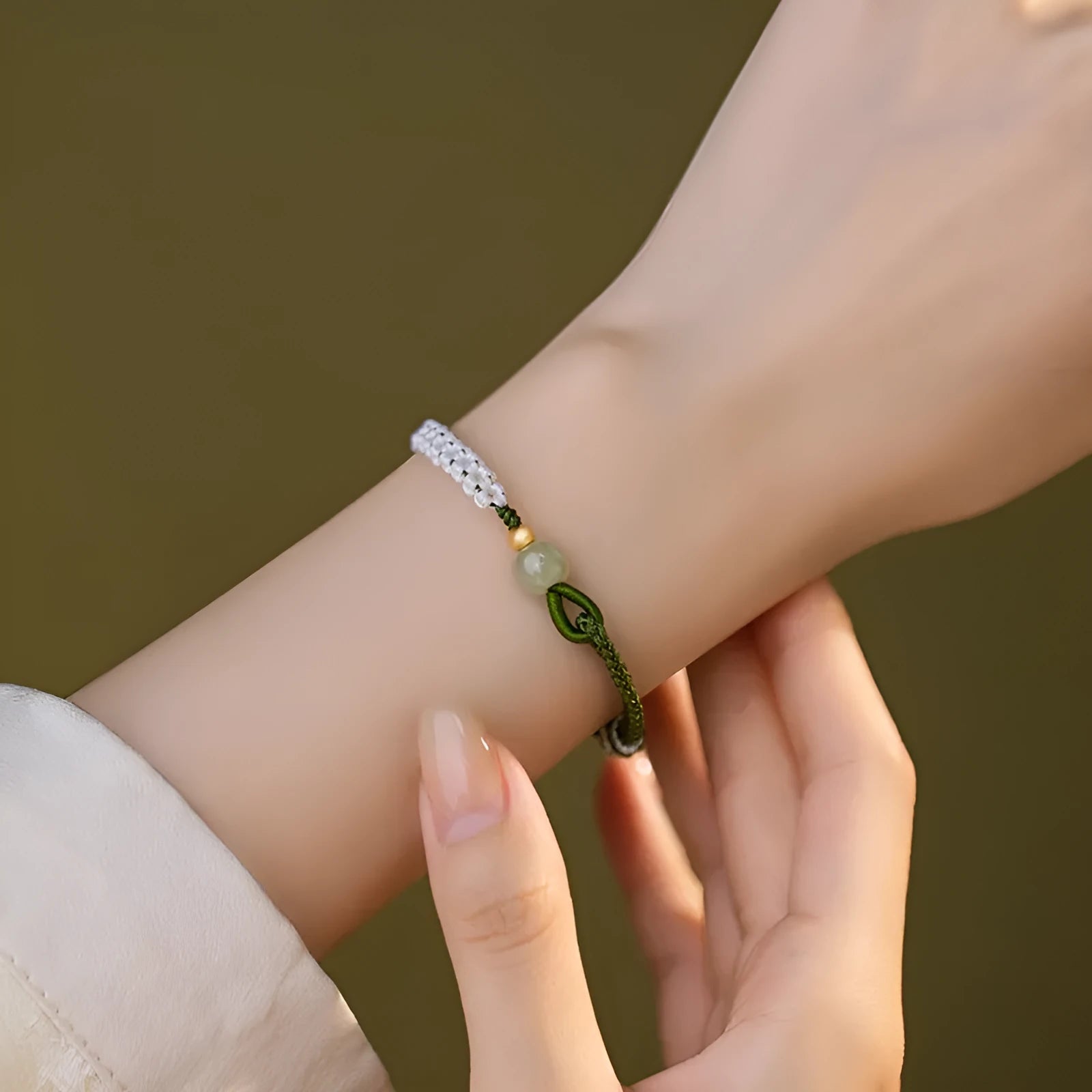Women's Chinese national bracelet with Hetian jade, sterling silver, and colourful cord carrying strap