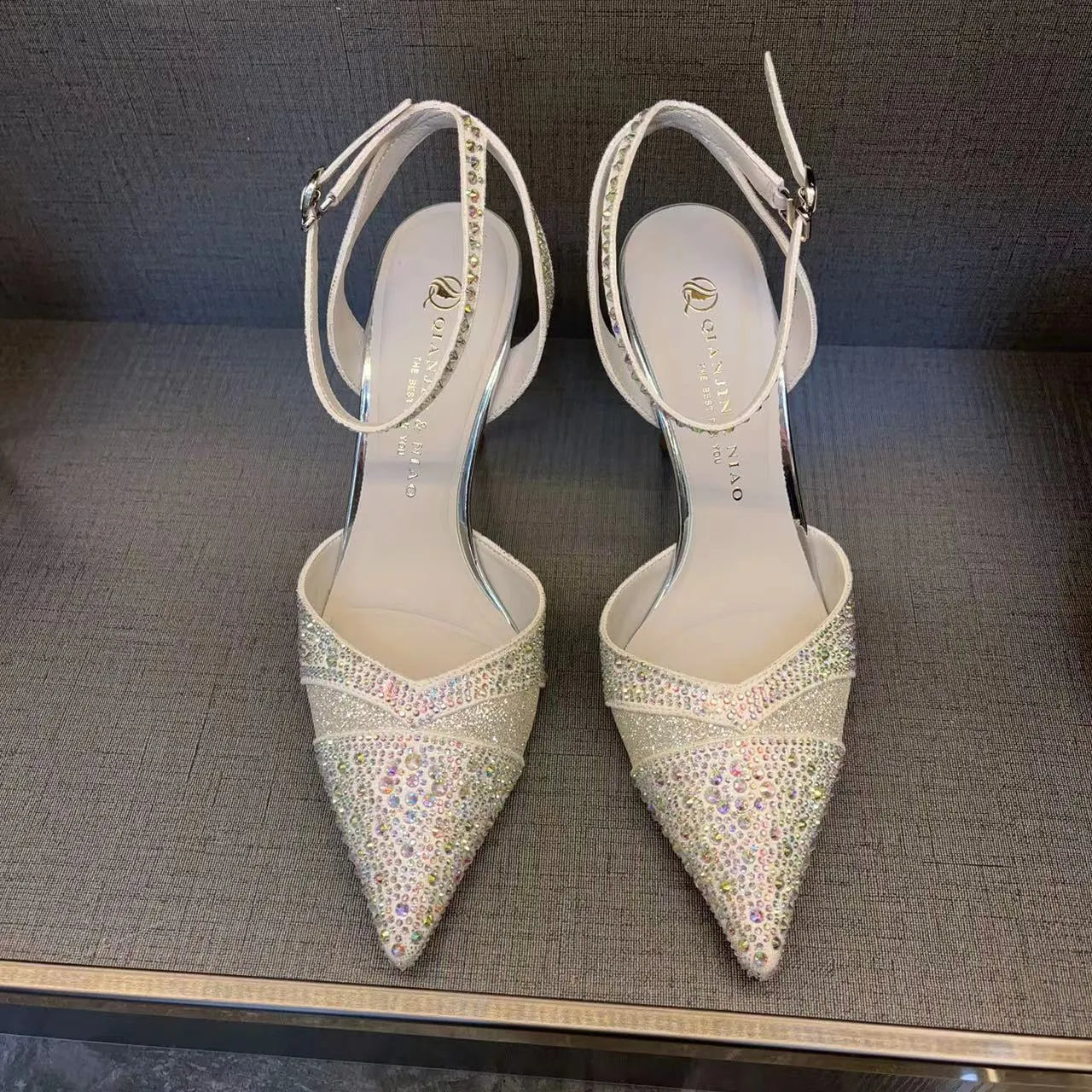 Women's hollow high heels with red sole, pointed toe stiletto design in black and silver colour options