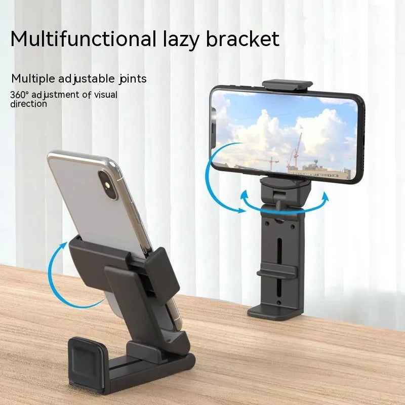 360 rotary collapsible mobile phone holder in black on a desk, with a phone propped up in landscape mode