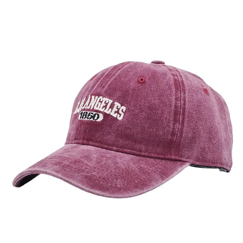 Adjustable peak cap with embroidered letters in distressed retro style, showing conical crown and 7cm brim