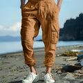 Men's loose-fit linen trousers with ankle ties and multiple pockets in Army Green.