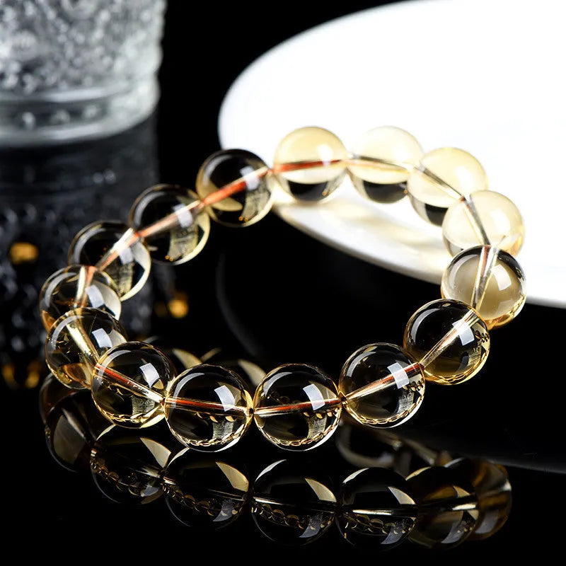Natural citrine scattered beads ball bracelet in 7A and 6A colour grades on a white background.
