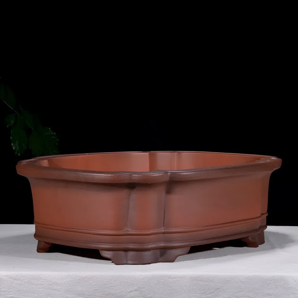 Large antique-style purple clay flowerpot with Chinese design for outdoor garden use.