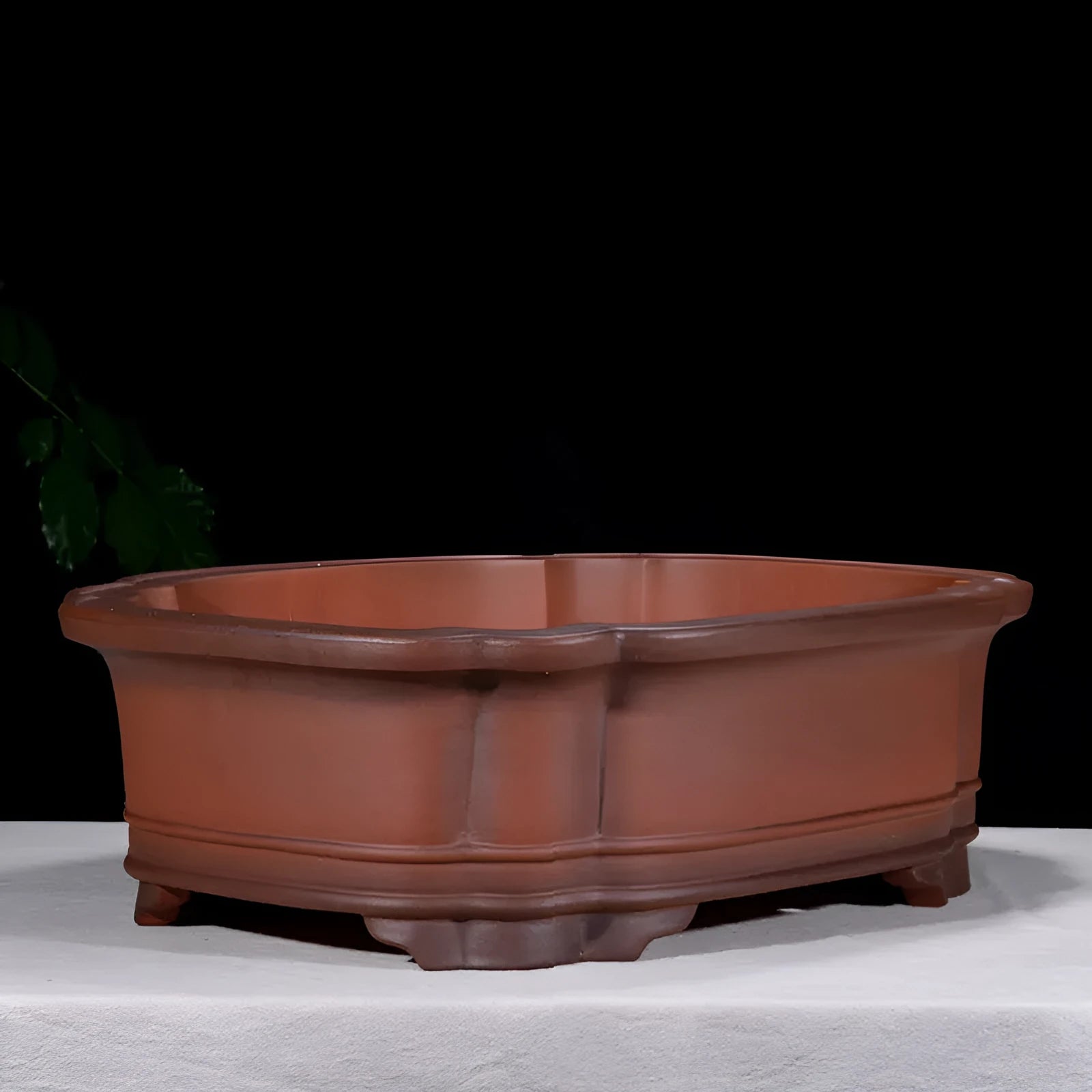 Large antique-style purple clay flowerpot with Chinese design for outdoor garden use.