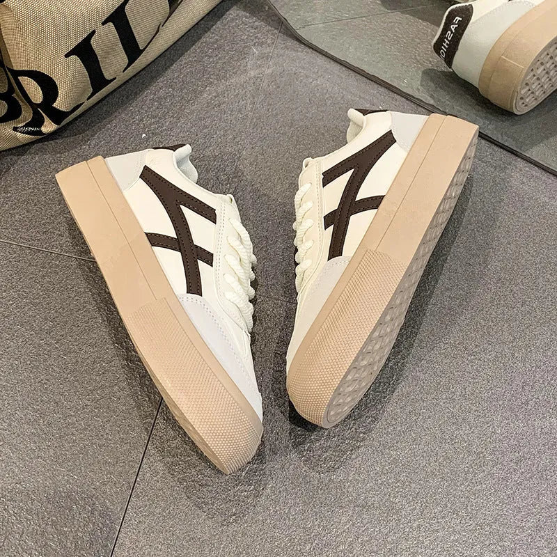 Classic low top sports casual board shoe with rubber sole and patent finish, brown colour, side view
