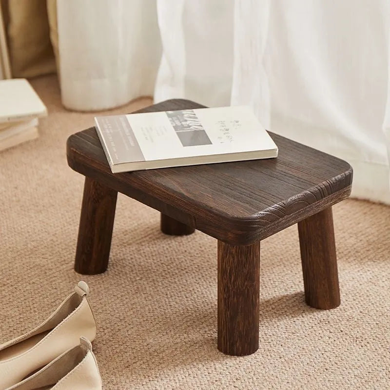 Distressed wooden stool with bracket structure legs in rustic finish
