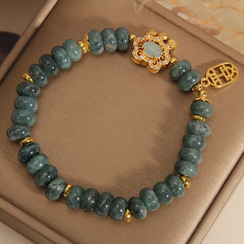 Natural emerald jade abacus bead safety lock style bracelet on women's wrist, alloy frame, green gemstone beads