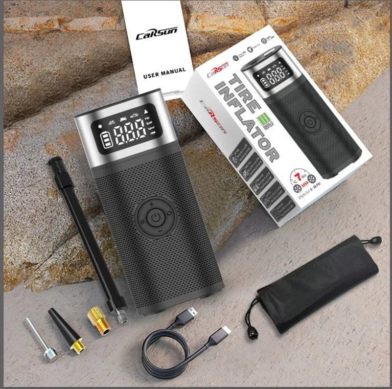 Black portable wireless vehicle air pump with USB charging cable and multiple inflation nozzles including bicycle and ball attachments